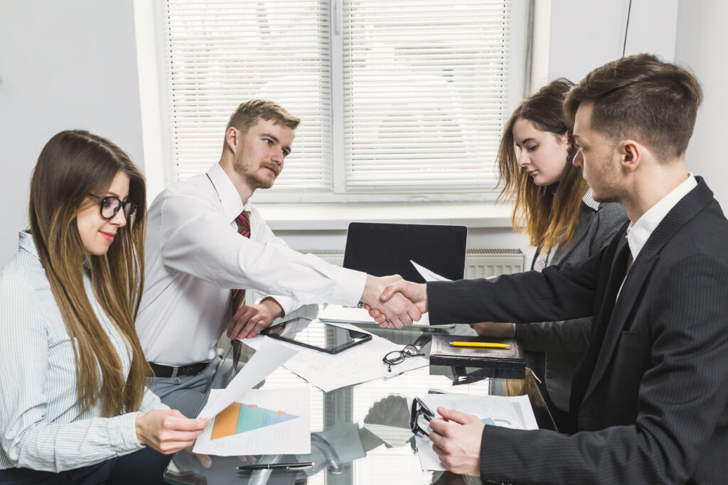 businessman shaking hand with his colleague office